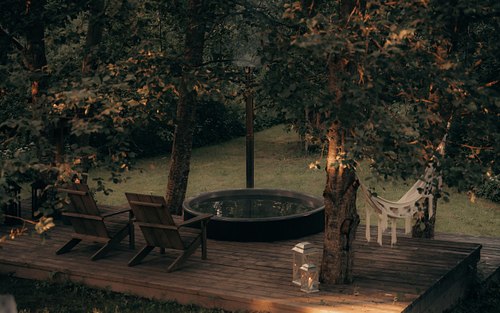 Outdoor seating area surrounded by peaceful Latvian forest