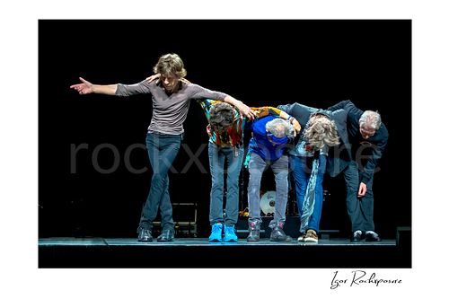 Horizontal color image of Mick Jagger, Mick Taylor, Keith Richards, Ronnie Wood and Charlie Watts of The Rolling Stones taking a bow on stage