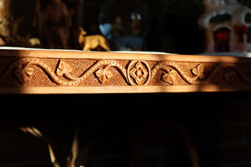 Trestle table skirt carving in dramatic lighting