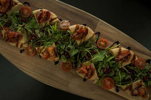 Freshly prepared food served on a wooden board, photographed from above in natural light