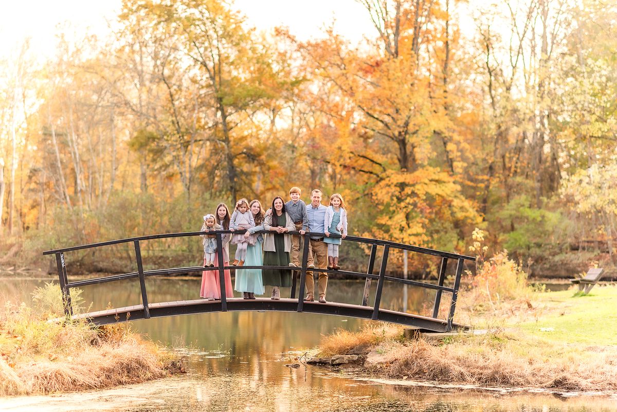 Family of eight on bridge over pond Brush Creek Park with Cranberry Township, PA newborn photographer