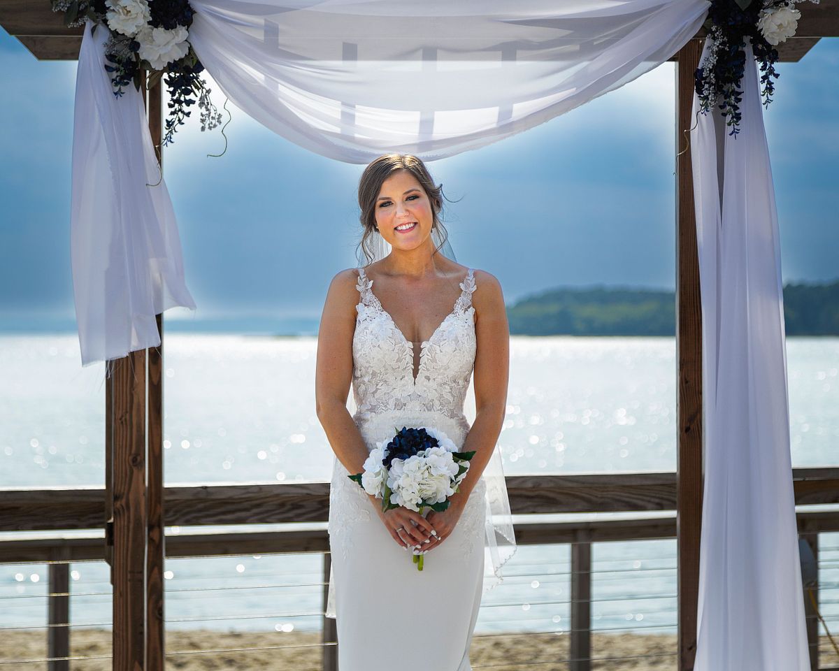 bride posing at the beach in dewey beach, hyatt