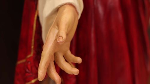Restored and painted hand on a Sacred Heart Statue that was badly destroyed.