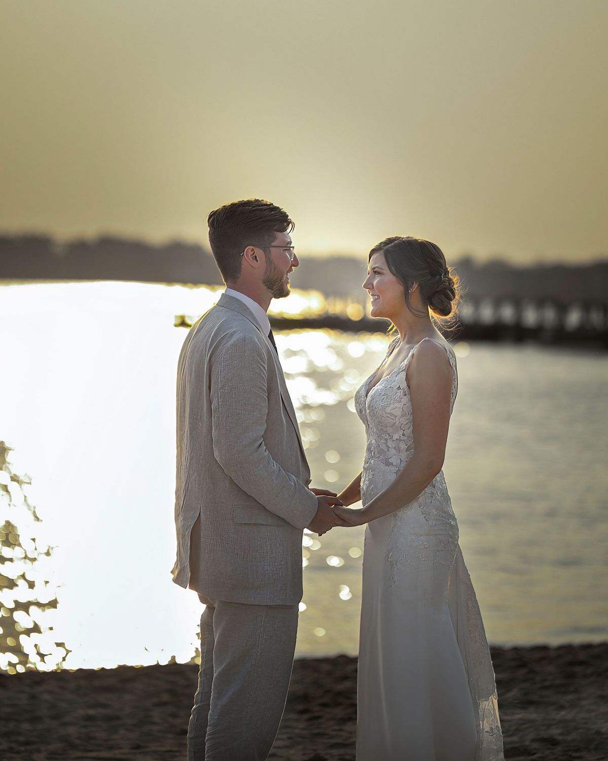 bride and groom posing at the beach at sunset in dewey beach