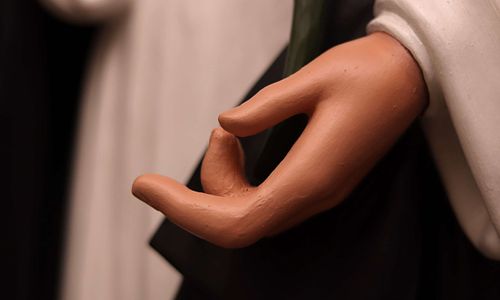 Saint Dominic statue's hand after repair and repainting.