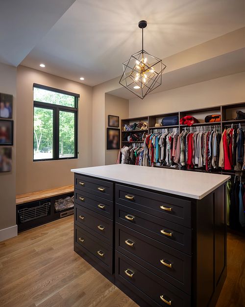 Walk-in dressing room closet, Built-in drawers, custom closets, shoe bench, pull-out basket drawers, chandelier, power outlets in closet