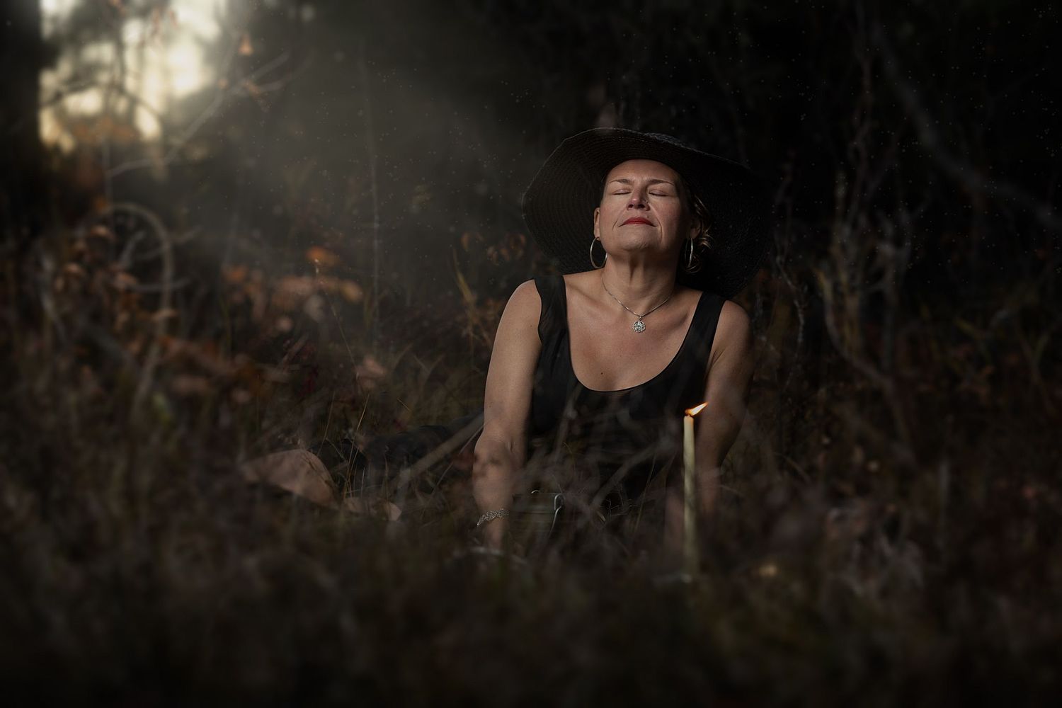 A witch enjoys the light leaking into her grove.