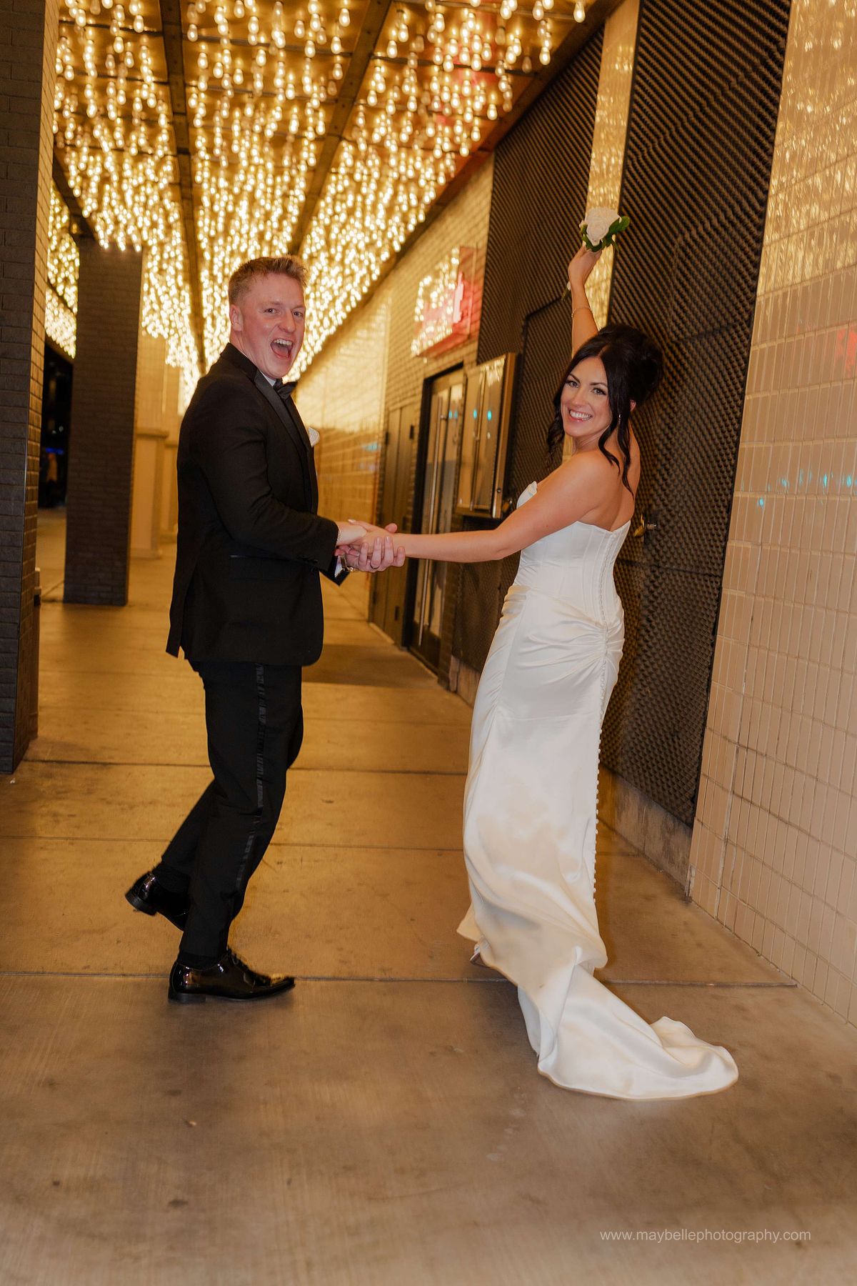 Romantic elopement photos at Carousel Bar in Downtown Las Vegas with couple celebrating with champagne
