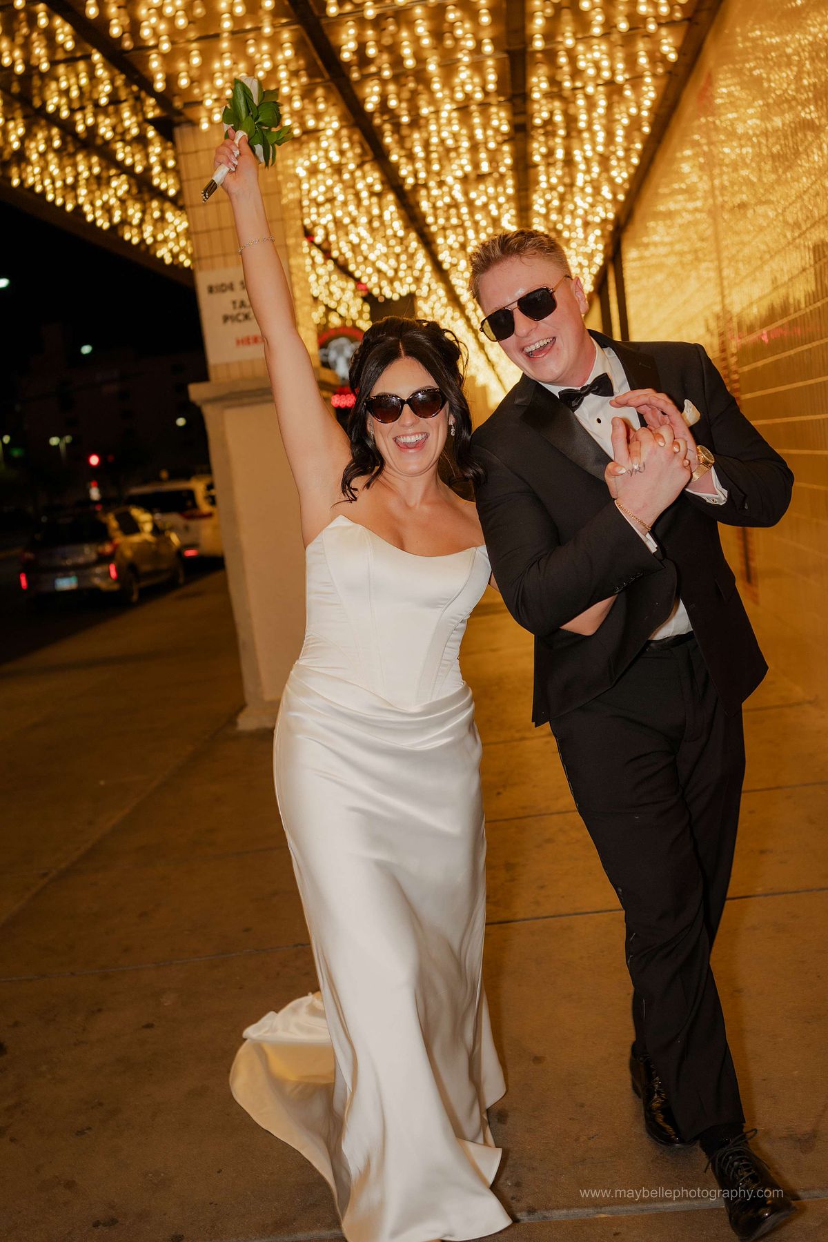 Romantic elopement photos at Carousel Bar in Downtown Las Vegas with couple celebrating with champagne