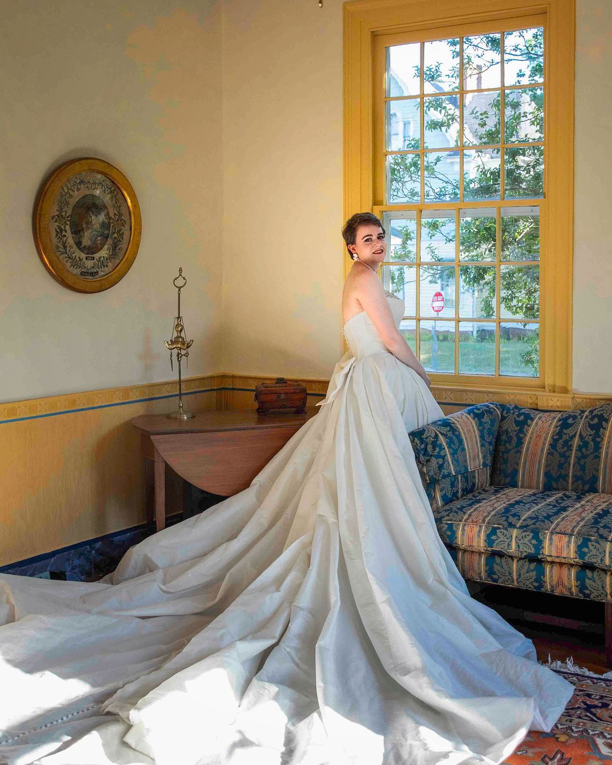 bride is posing at the window at poplar Hill mansion, Salisbury, md