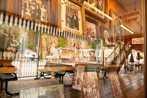 Storefront in Keystone, South Dakota offering your photo in Western themes, with downtown scenery visible