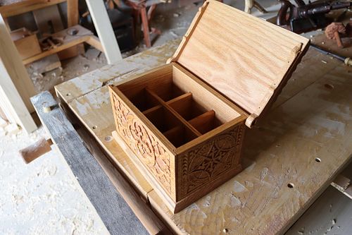 interior of the carved oak box showing the dividers made to hold Glencairn whiskey glasses