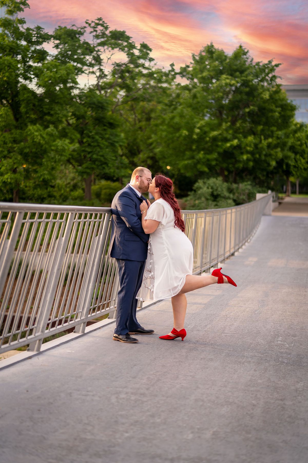 Engaged couple sharing a candid moment during golden hour in Oklahoma.