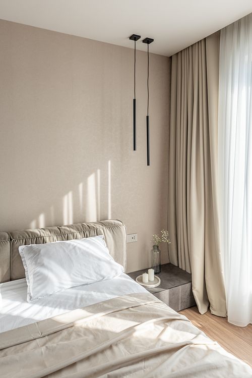 Bedroom illuminated by warm sunlight, highlighting minimalist design &ndash; Scala project