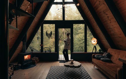 A-frame cabin bedroom with warm wooden textures and natural light