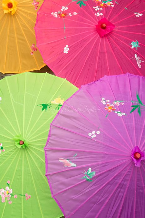 An orange, fuchsia, green and purple parasol