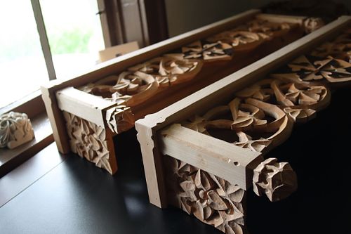 the shelves from an angle that shows the flower carving on the sides