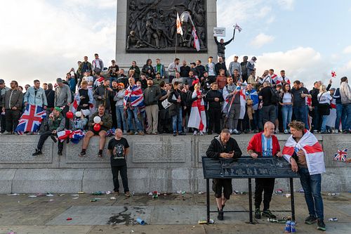Protesters climb Trafalgar Square plinth during “Unite the Kingdom” rally, London, UK