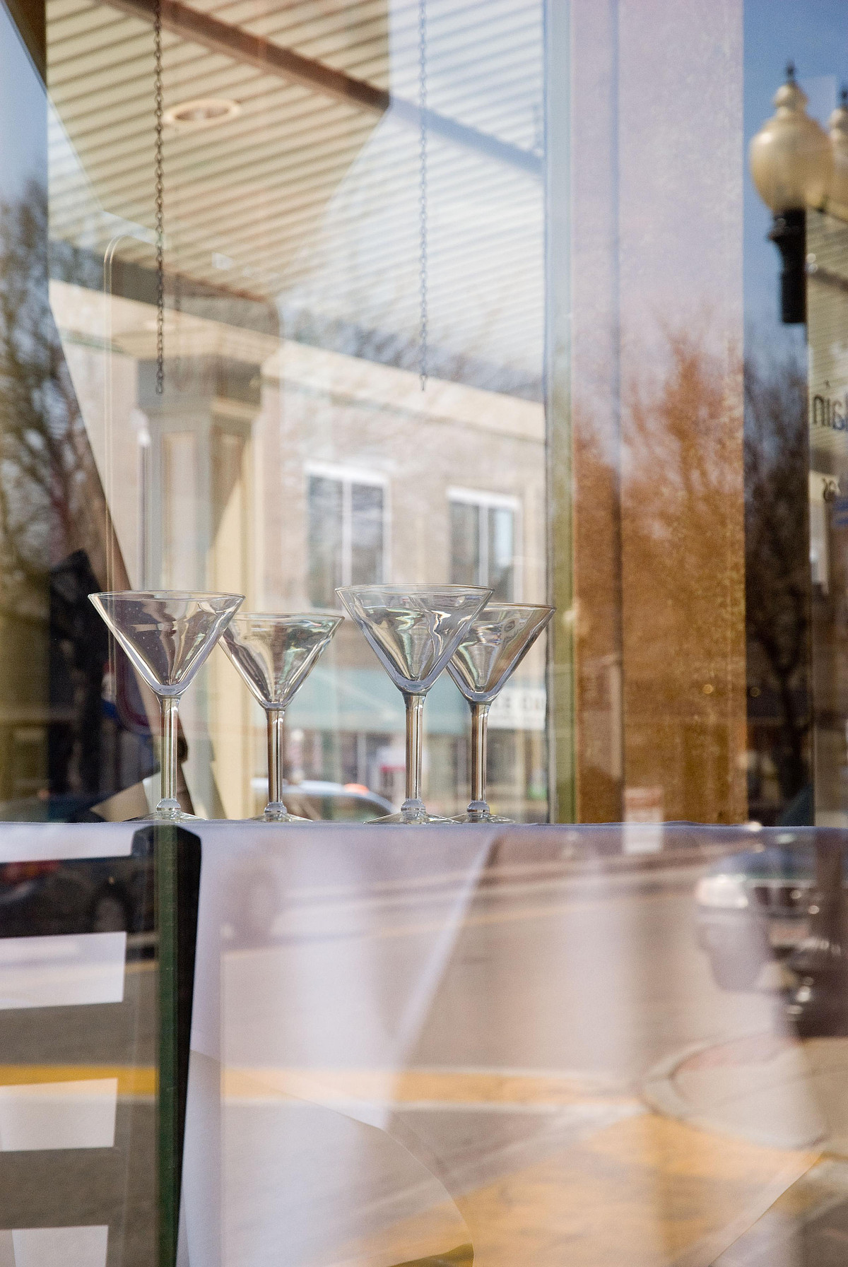 Martini glasses on a restaurant table with American main street in background