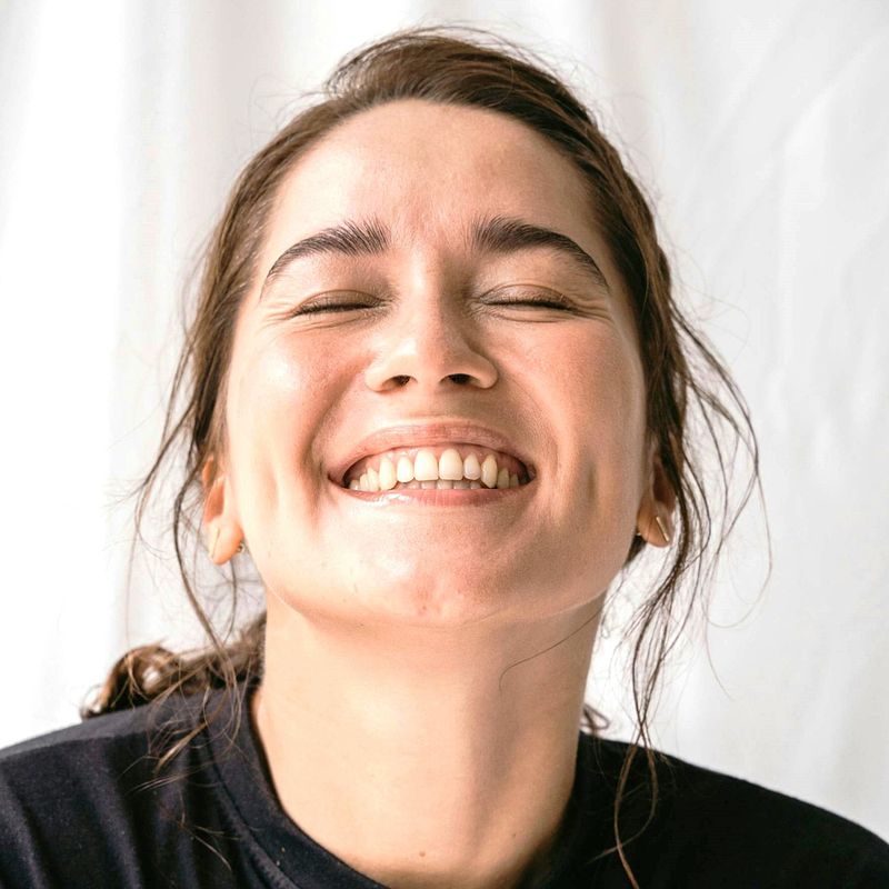 smiling woman with nice teeth and hear head tilted back
