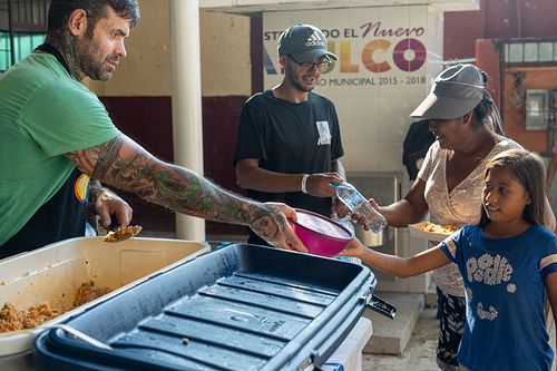 José Andrés interacting with local community members in Acapulco during World Central Kitchen relief efforts — by David Andrade