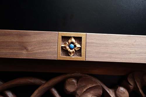 carving of virgin's bower flower in border of custom door panel