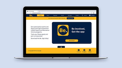 Mockup of the website home page showing the high-contrast yellow, blue and white colour palette, a clear navigation menu, and a call-to-action button linking to the Be Campaign app download.