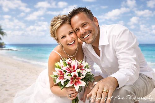 A joyful mature couple smiling on a sunny beach after their intimate wedding ceremony in North Central Florida, captured by Legacy of Love Photography.