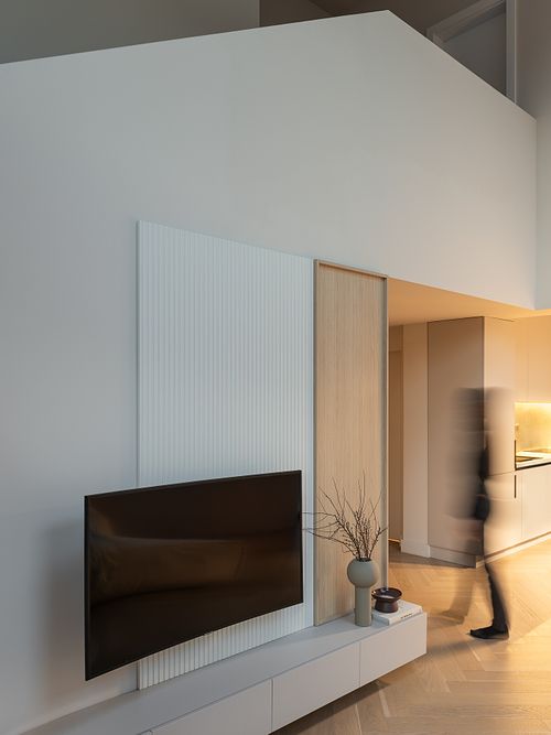 Dynamic interior photograph with subtle human presence in a minimalist setting – Faget project