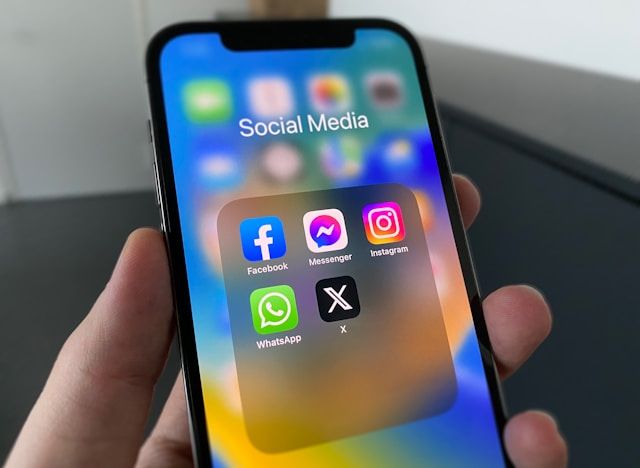 Social media icons shown on a phone