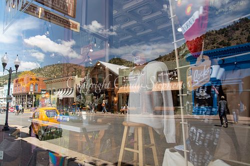 Idaho Springs Colorado lively main street yellow car mountain backdrop