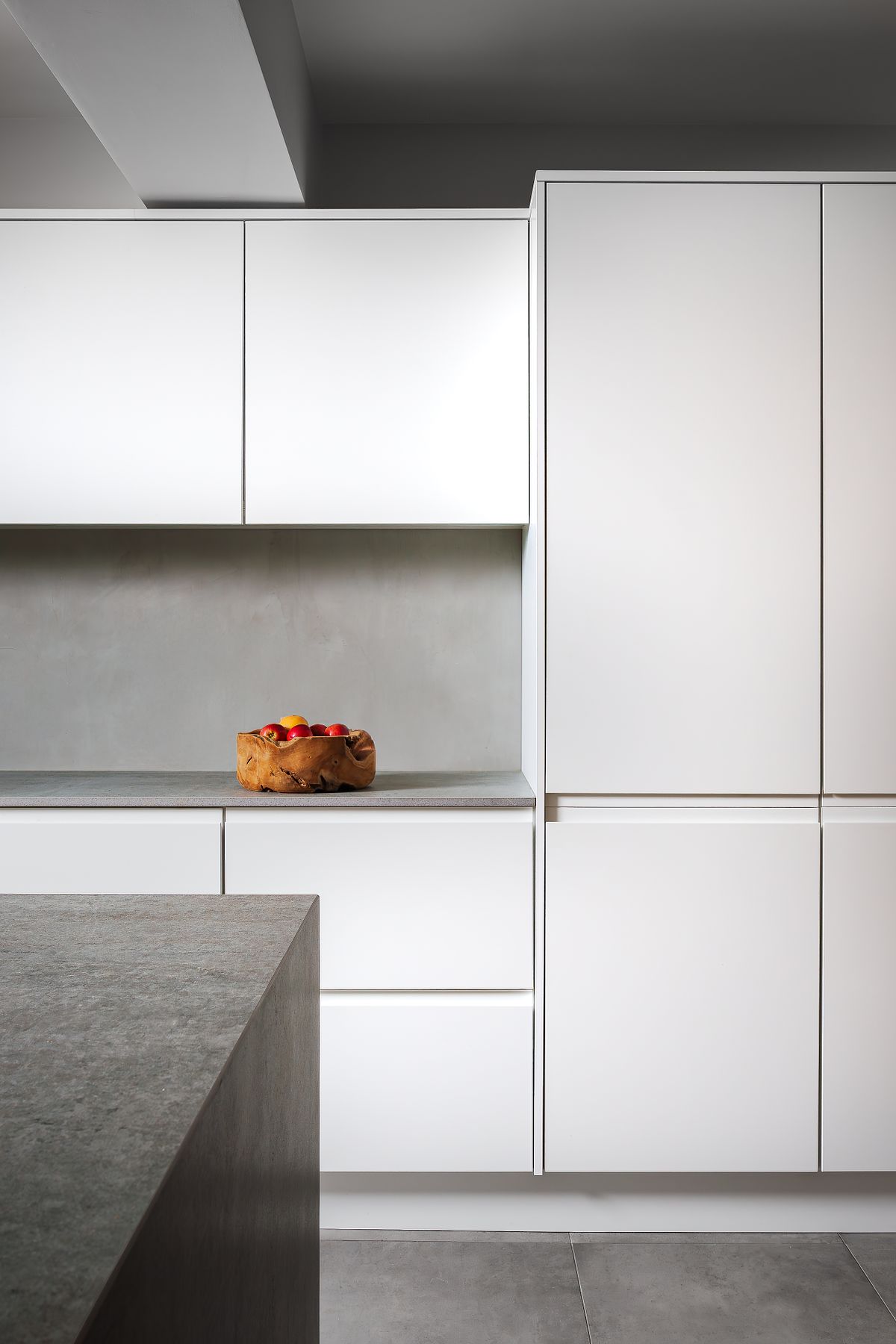 Close-up detail of modern white kitchen cabinets.