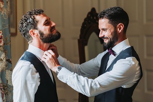 Groom and best mad getting ready