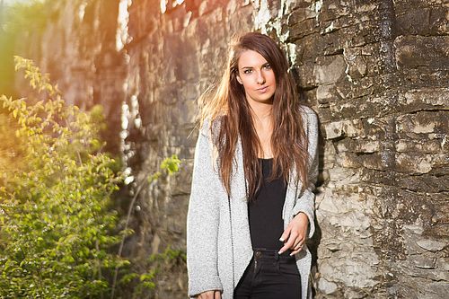 Moody outdoor senior portrait with balanced ambient and strobe lighting