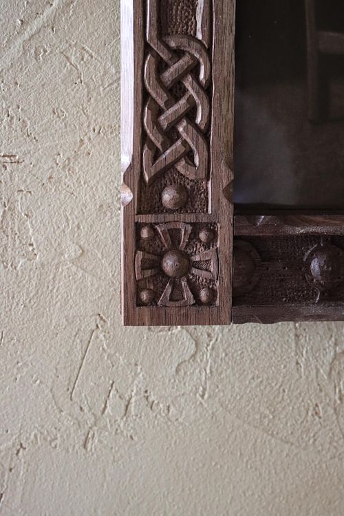 detail photo of the corner roundel where the strapwork meets the knotwork on the carved Celtic picture frame