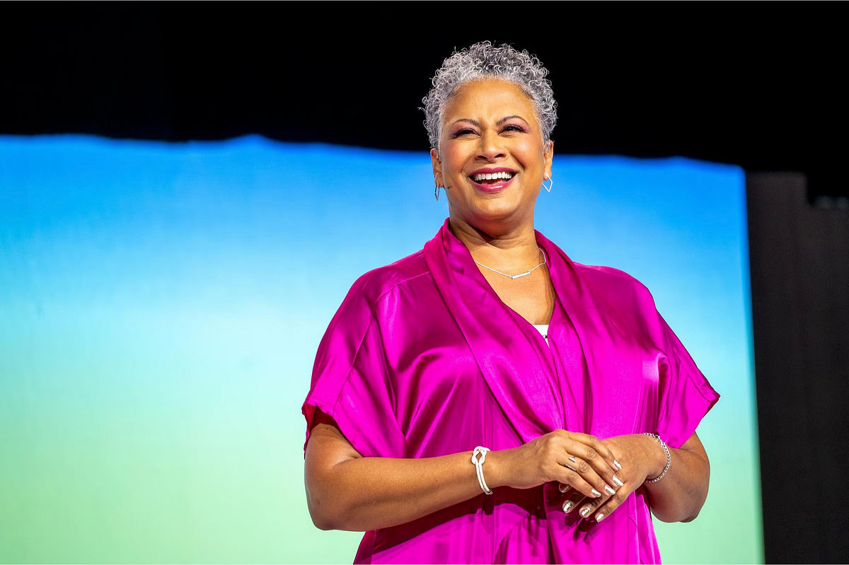 Keynote speaker presenting on stage at the Grace Hopper Celebration 2024 in front of a large audience of women in technology, highlighting leadership presence, inspiration, and representation at a major conference.