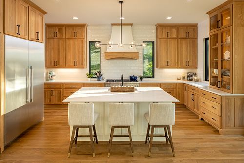 View of overall kitchen layout centered over the island and the stove