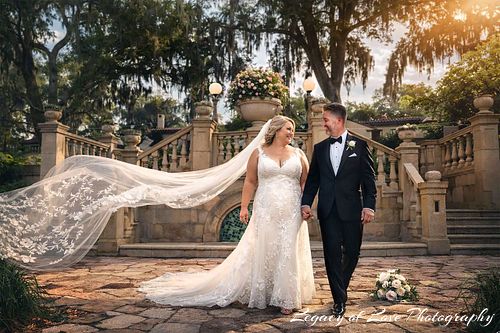 Dramatic wedding veil toss with a bride and groom walking on the historic stone patio at Epping Forest Yacht Club in Jacksonville.