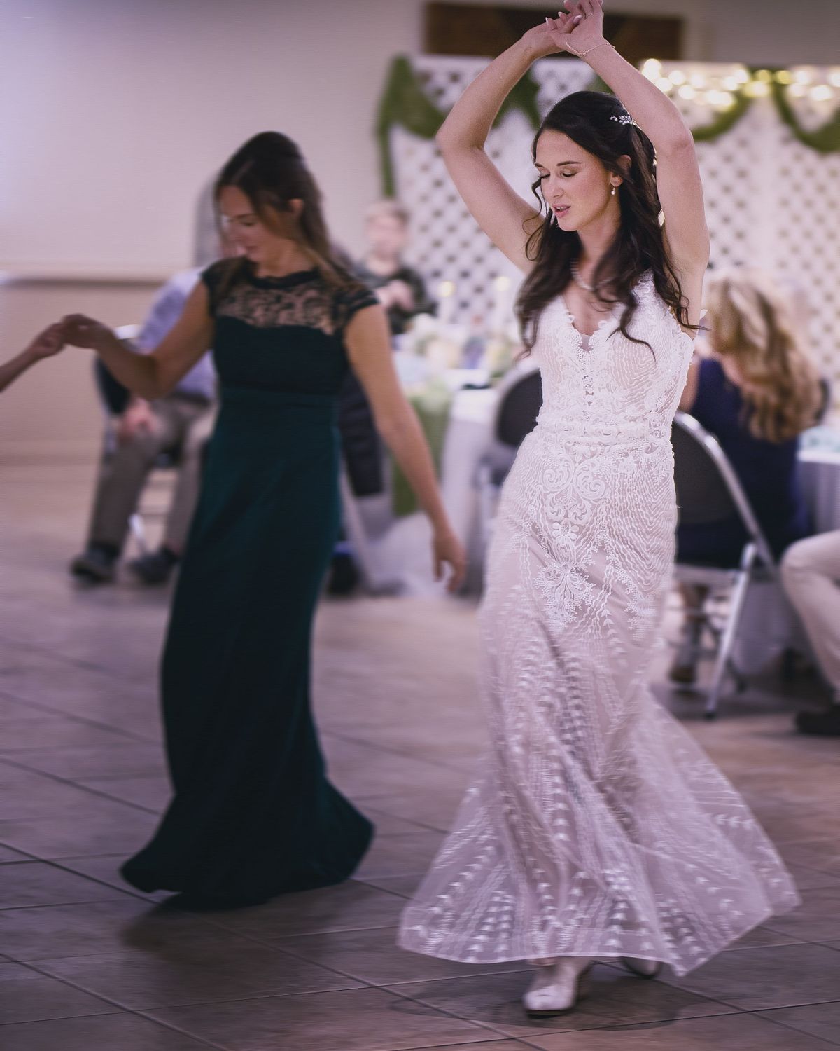a bride dancing by herself in a trance-like state at her wedding reception