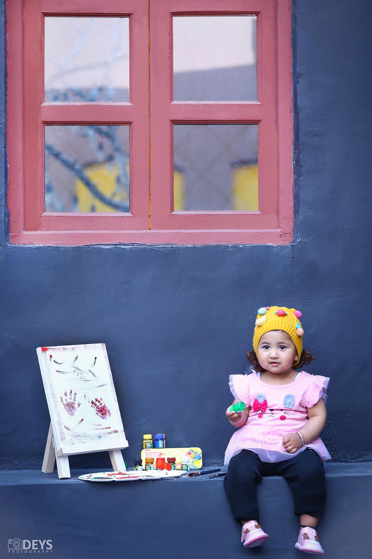 Baby girl painting at studio photoshoot