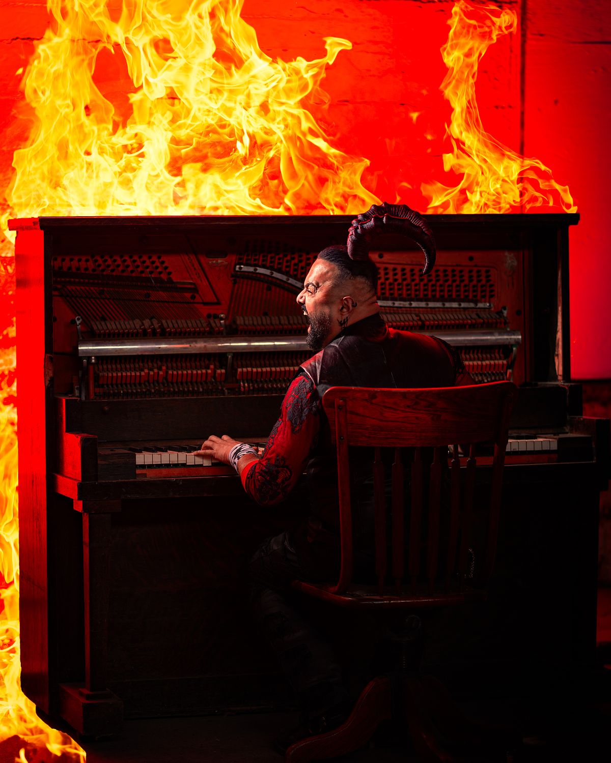 The Devil playing piano among hellfire.