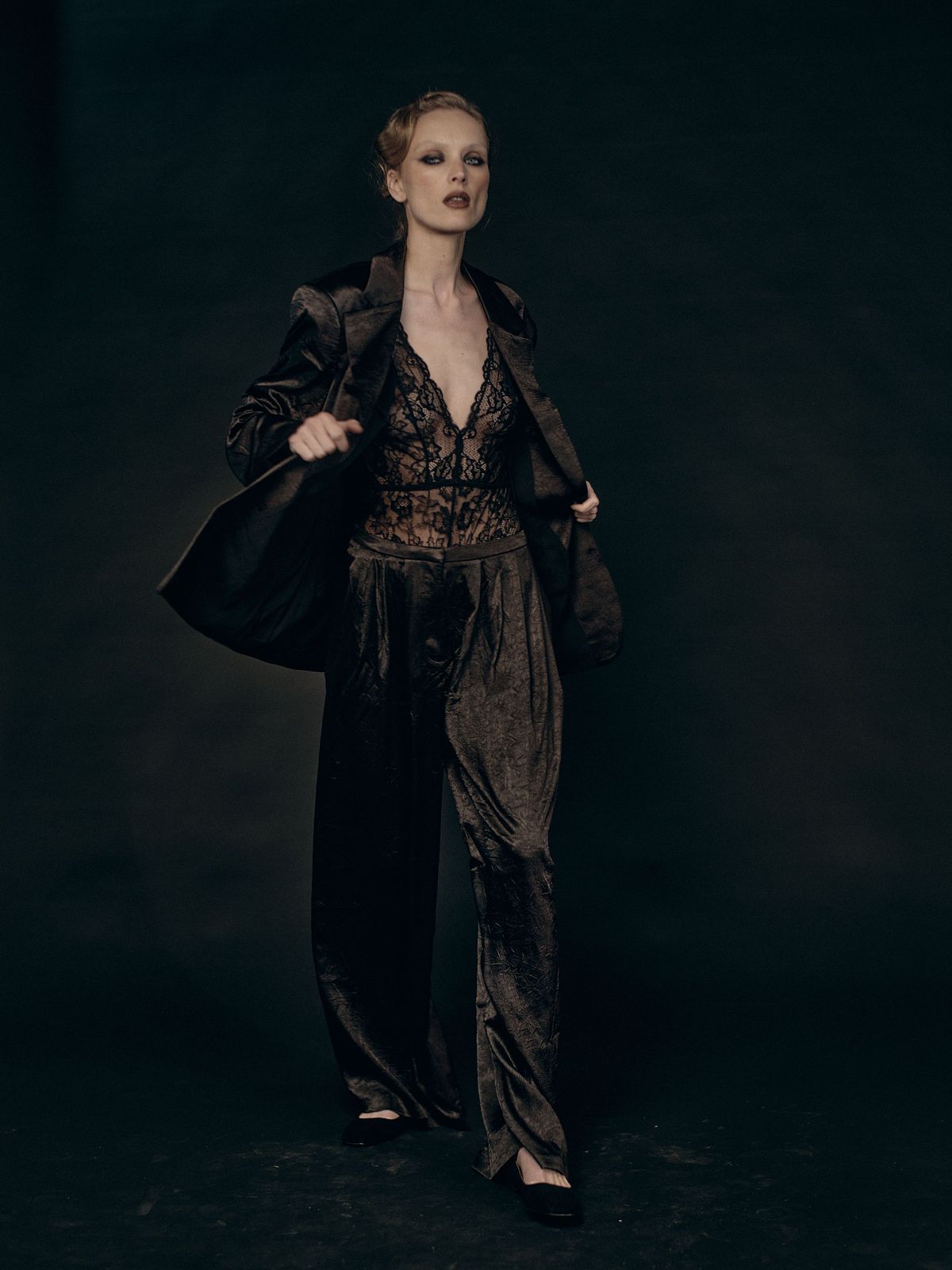 Cinematic full color editorial portrait of a female model in motion on a black background, shot for Scoutteen agency Prague, by Gabriel Matula.